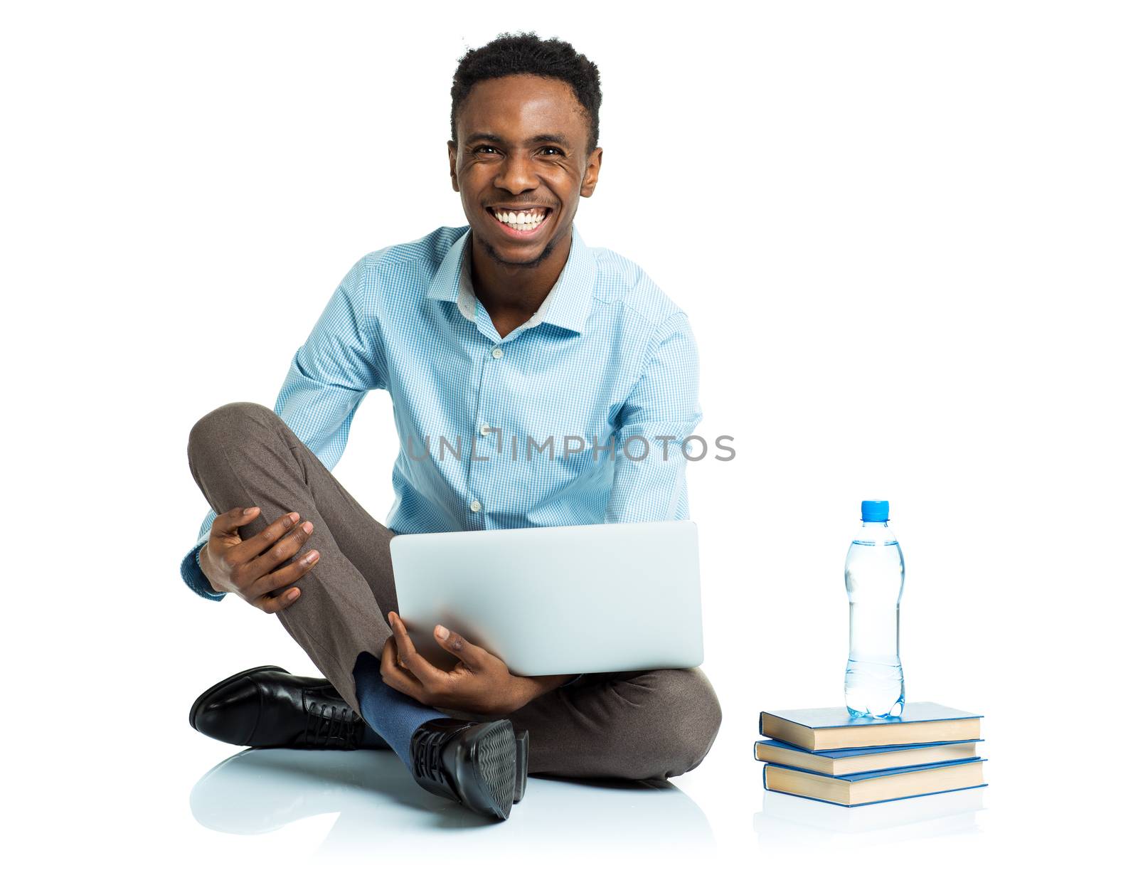 Happy african american college student sitting with laptop on wh by vlad_star