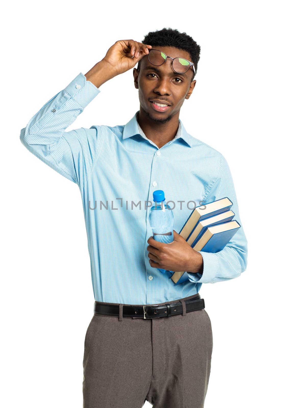 Happy african american college student standing with books and bottle of water in his hands on white background