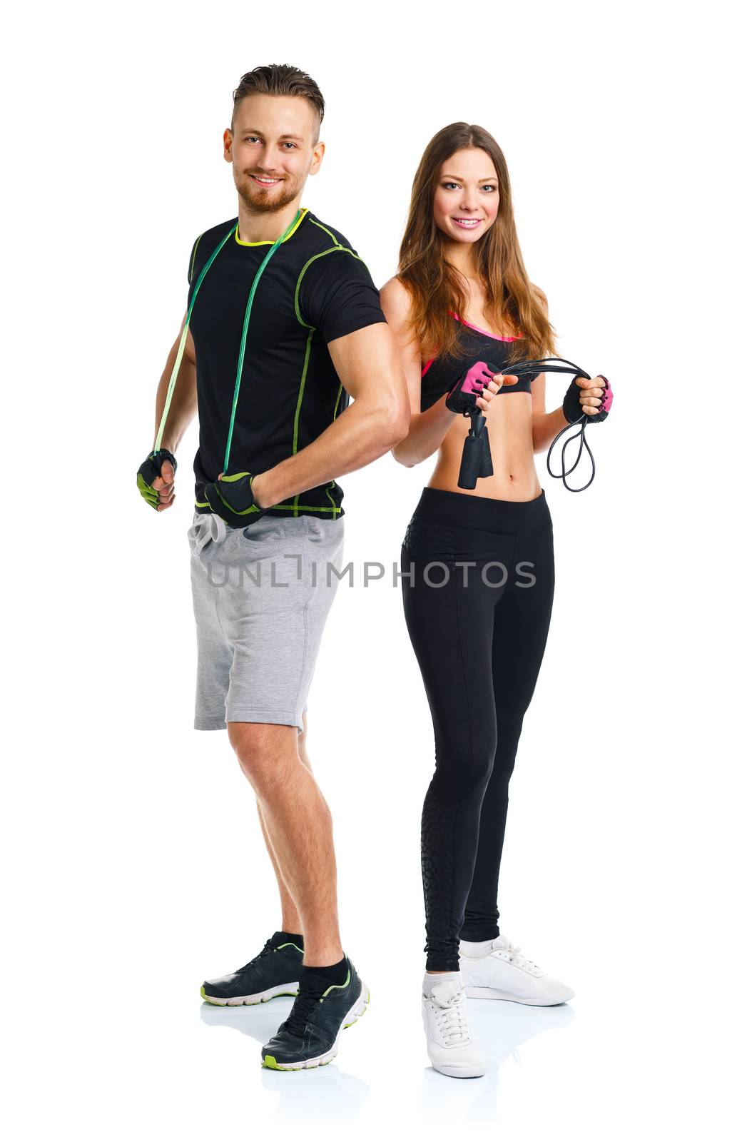 Happy athletic couple - man and woman with with ropes on the white background