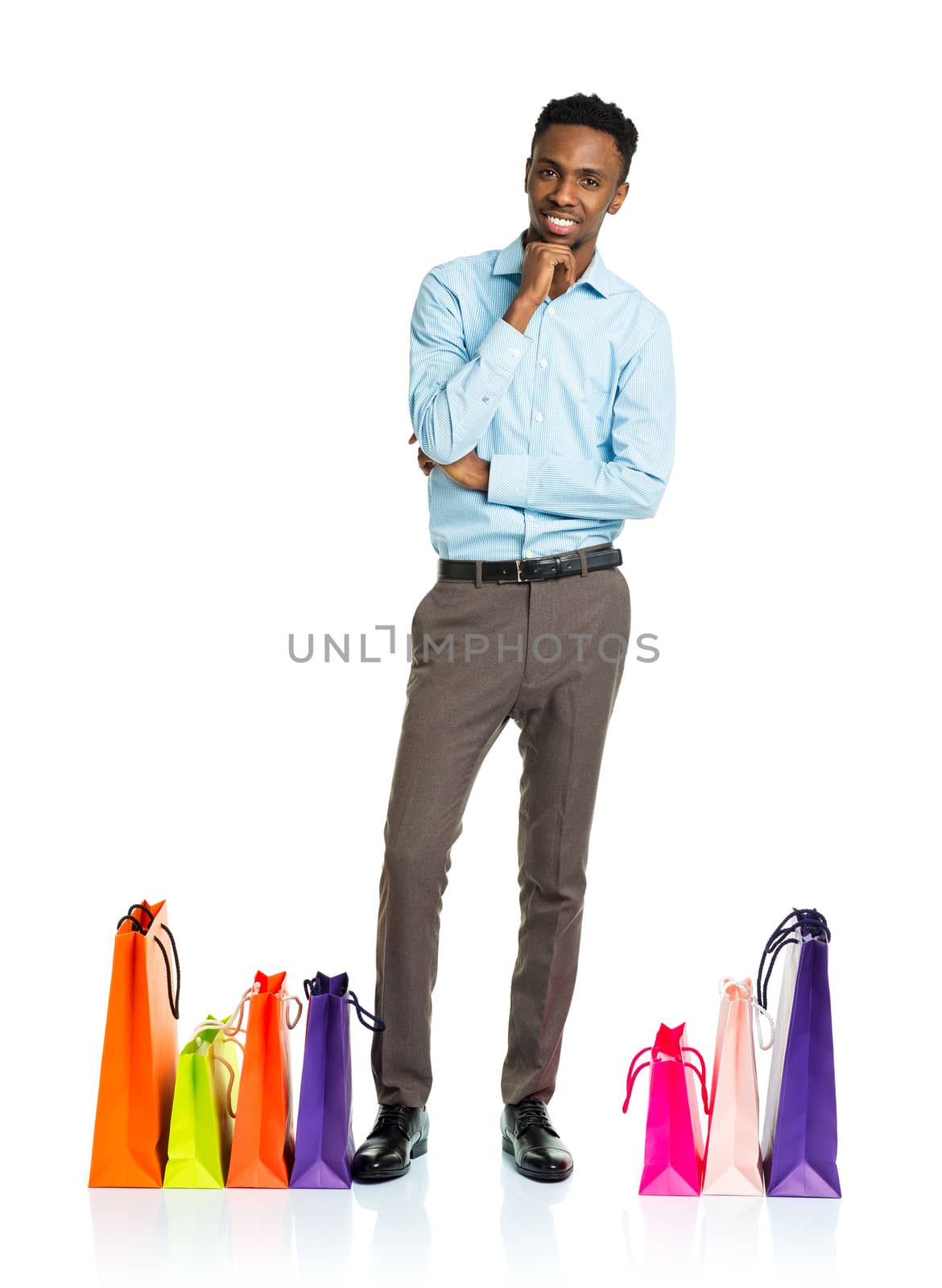 Happy african american man with shopping bags on white background. Christmas and holidays concept