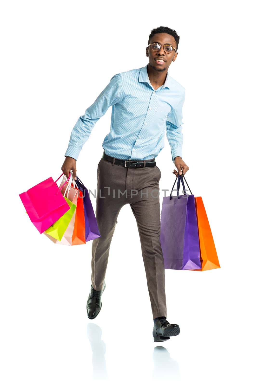 Happy african american man holding shopping bags on white backgr by vlad_star