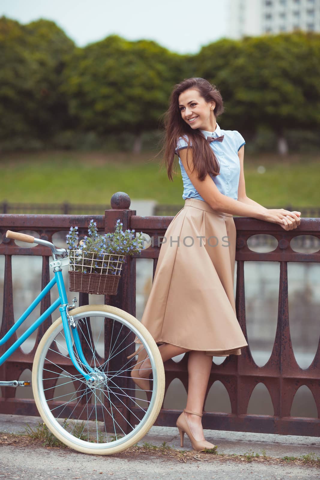 Young beautiful, elegantly dressed woman with bicycle. Beauty, fashion and lifestyle