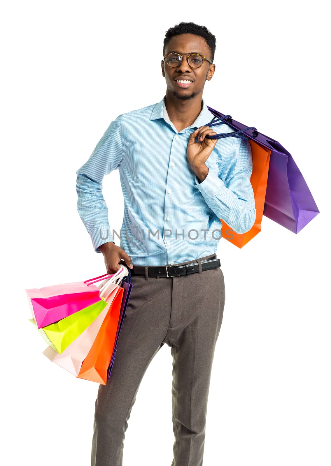 Happy african american man holding shopping bags on white background. Christmas and holidays concept