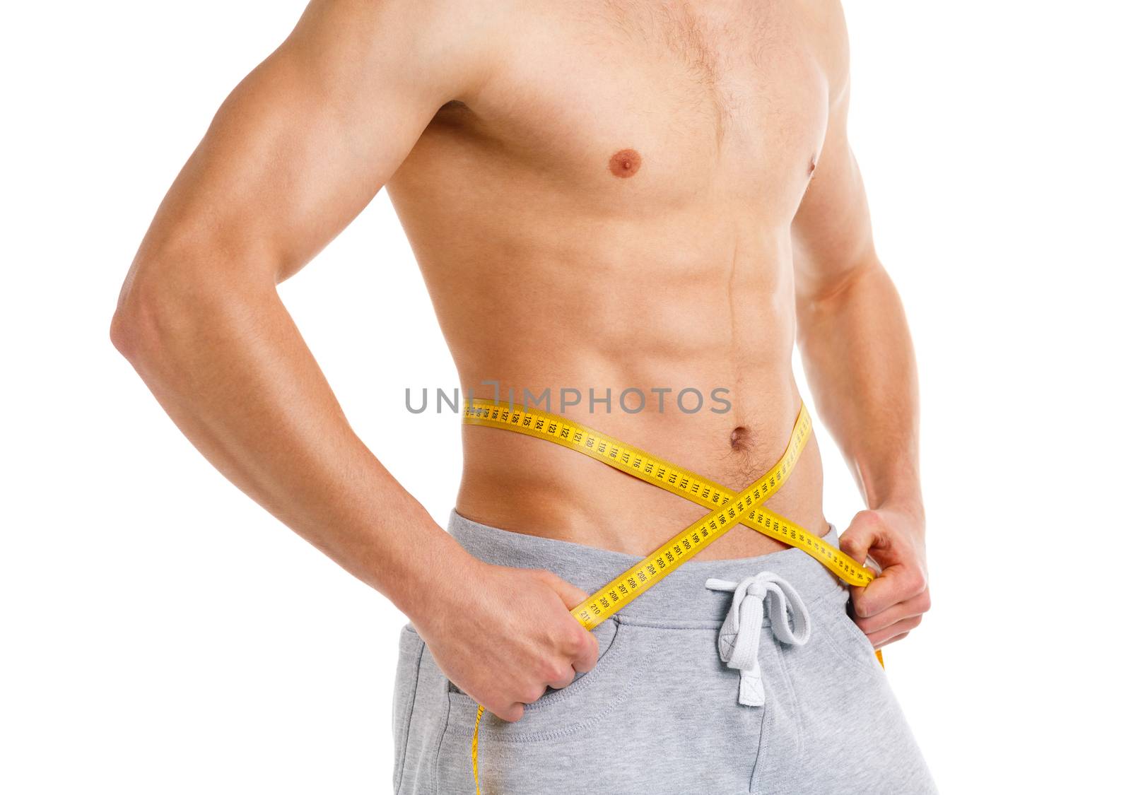 Athletic man with measuring tape on the white background