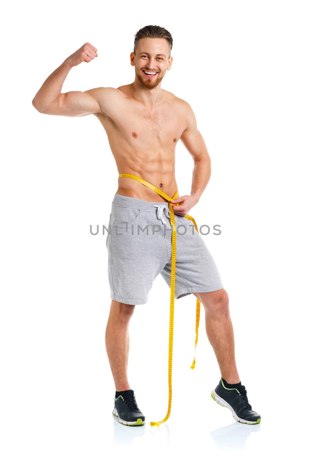 Athletic man with measuring tape on the white background
