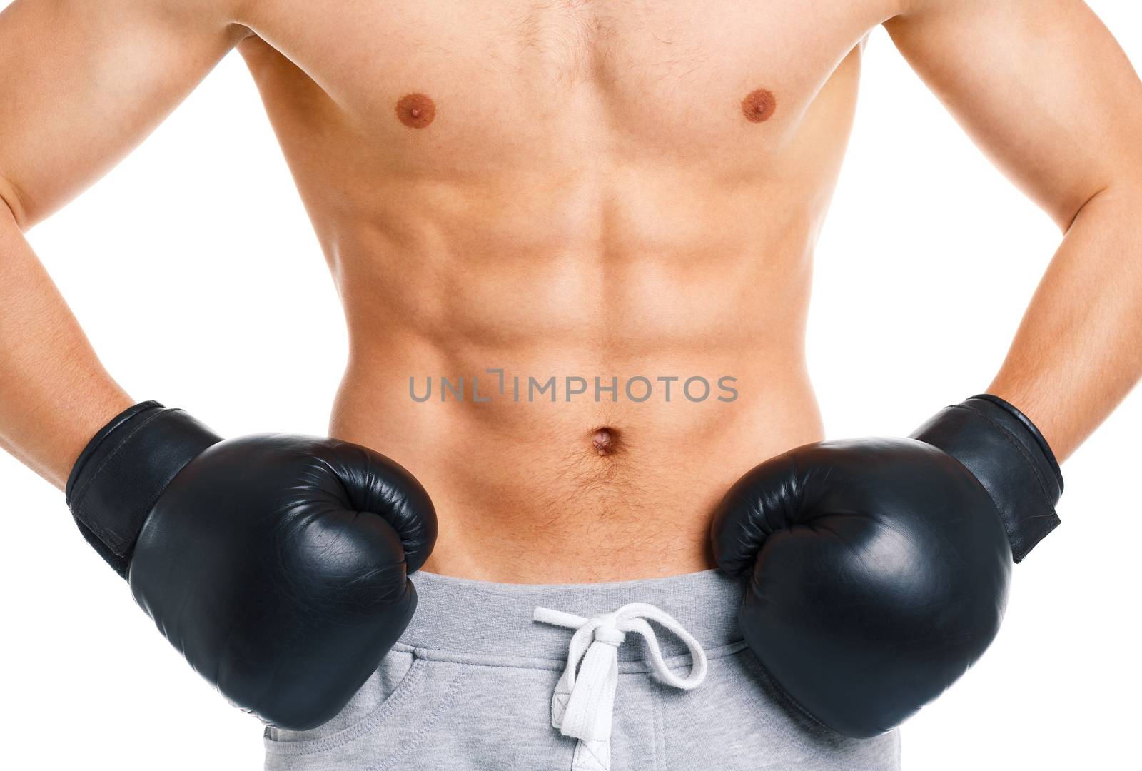 Athletic attractive man wearing boxing gloves on the white background