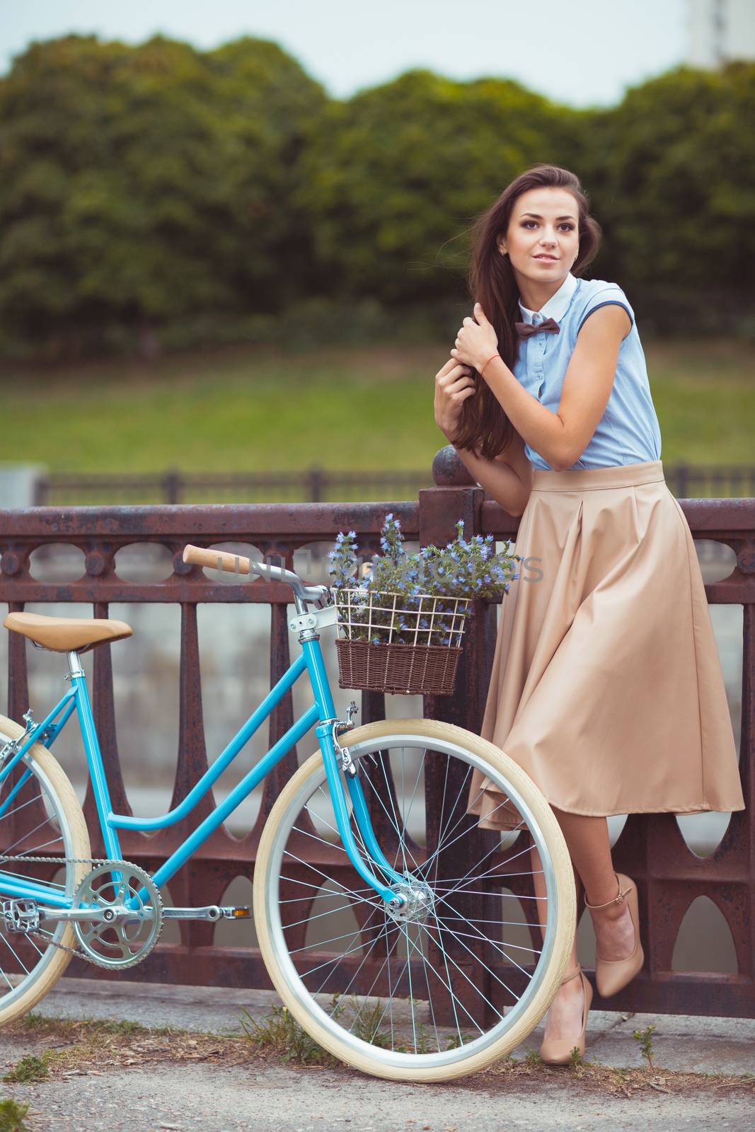 Young beautiful, elegantly dressed woman with bicycle in the par by vlad_star