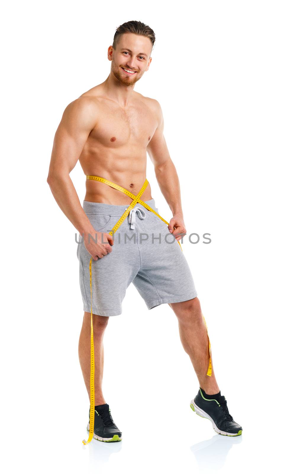 Athletic man with measuring tape on the white background