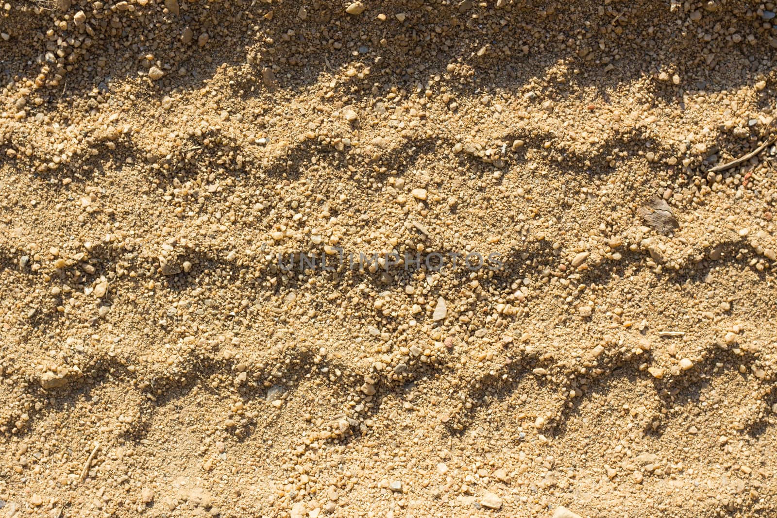 Car tire tracks on sand, as background