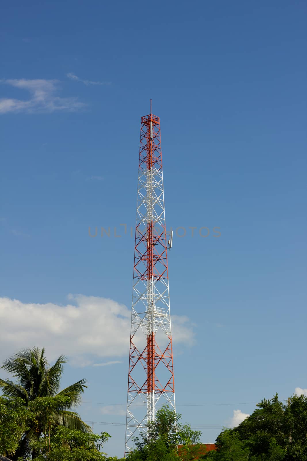 Antenna Tower of Communication, in background of blue sky and cl by a3701027