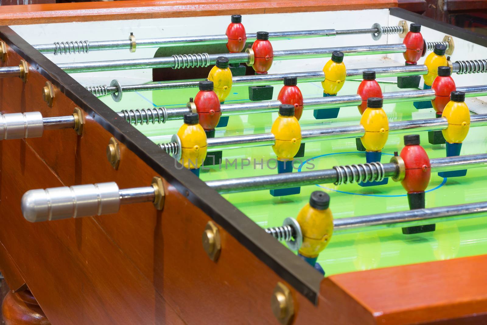 Table football game with yellow and red players