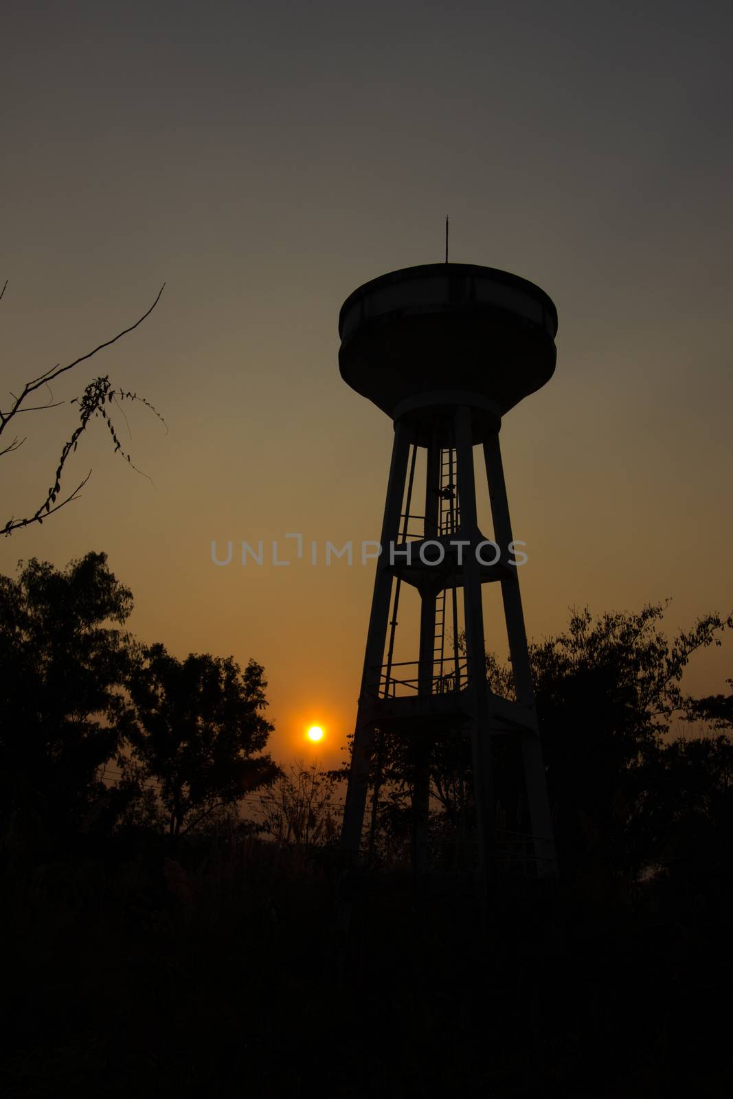 water tank with silhouette, sunset