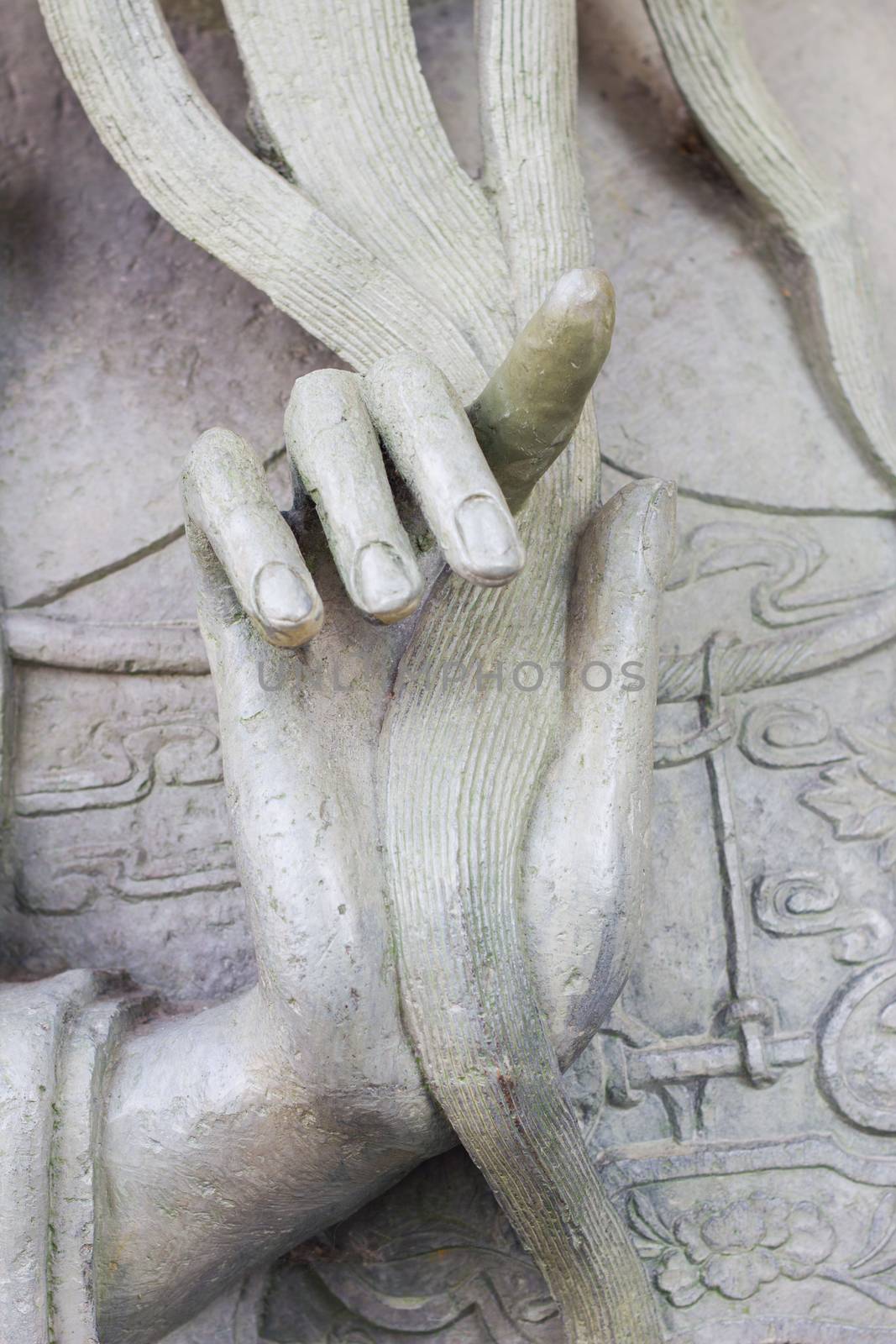 hand of antique chinese statue touching beard, in thai temple  by a3701027