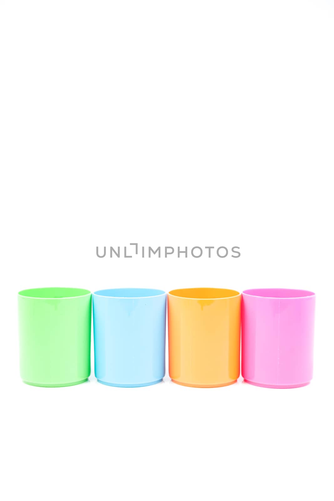 plastic cups colors. Colorful glass arranged in rows. Isolated white background