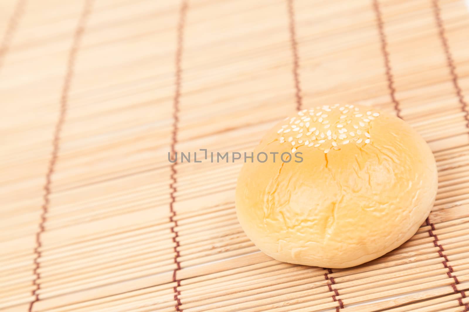 Bread sphere. A small white beans on top of bread. Placed on wood