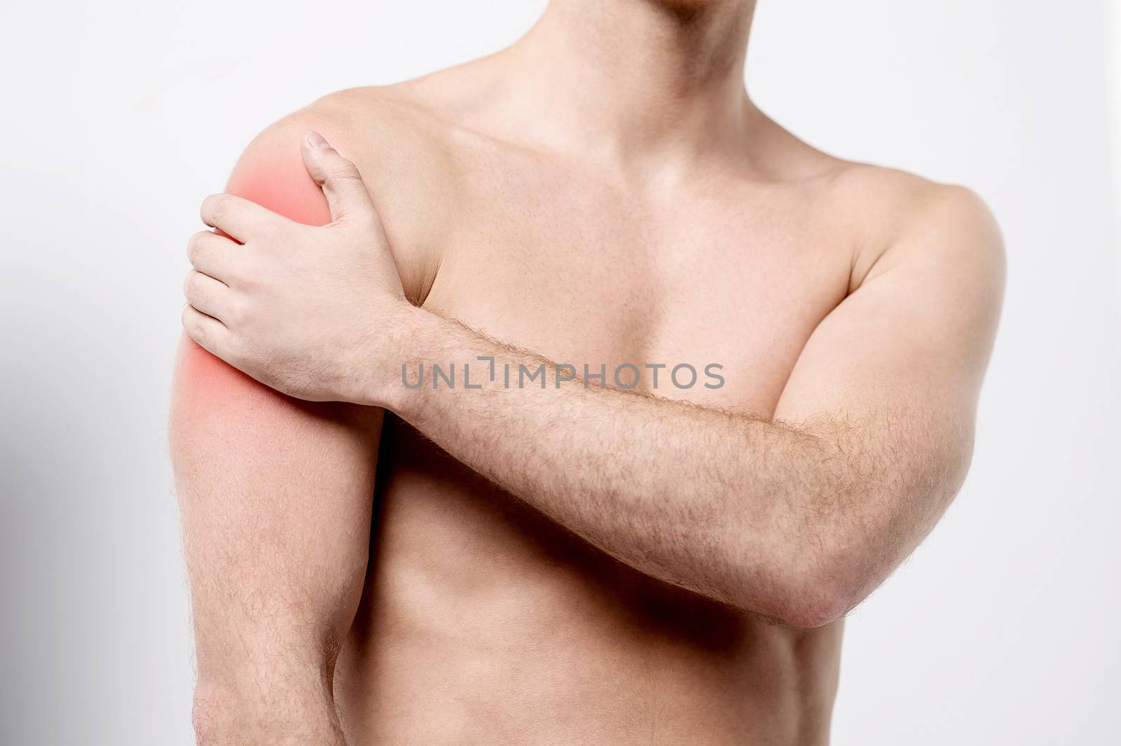 Muscular man discomfort on shoulder by stockyimages