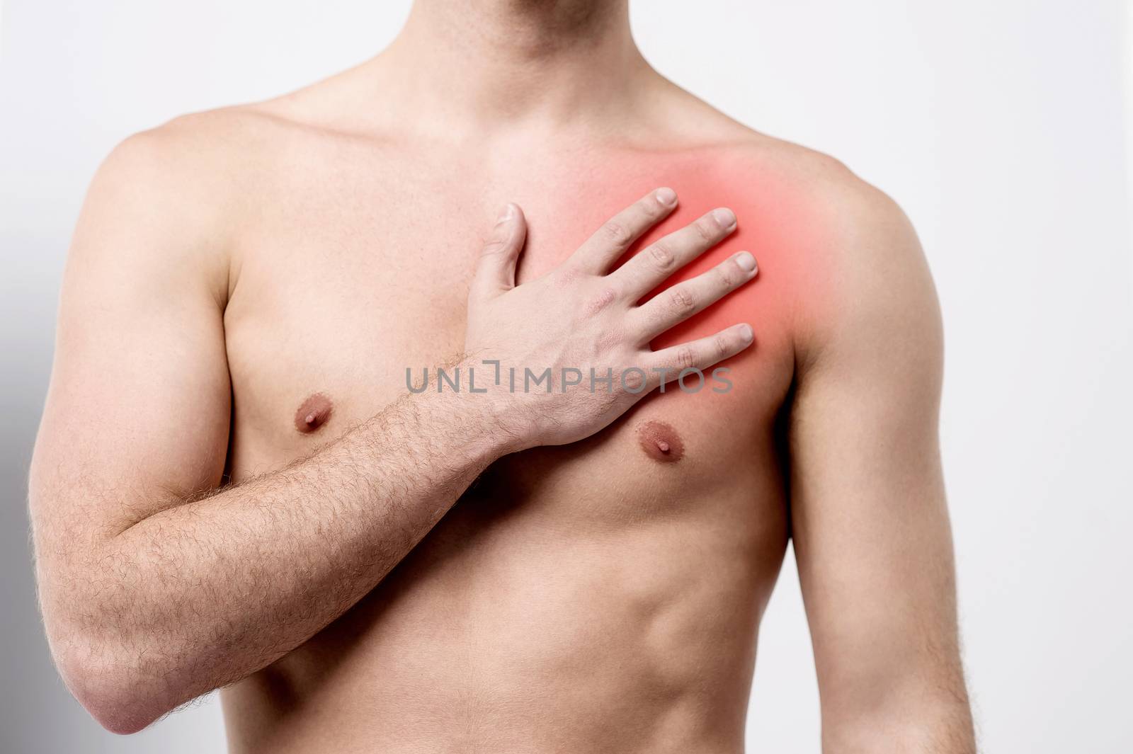 Male suffering pain on his chest muscle 