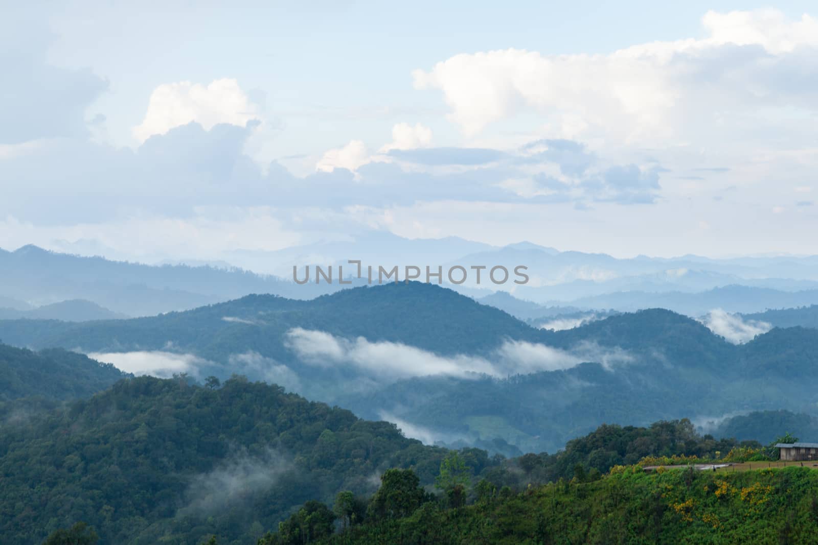 mist-shrouded mountains. High mountain complex. Fog in the morning and evening.