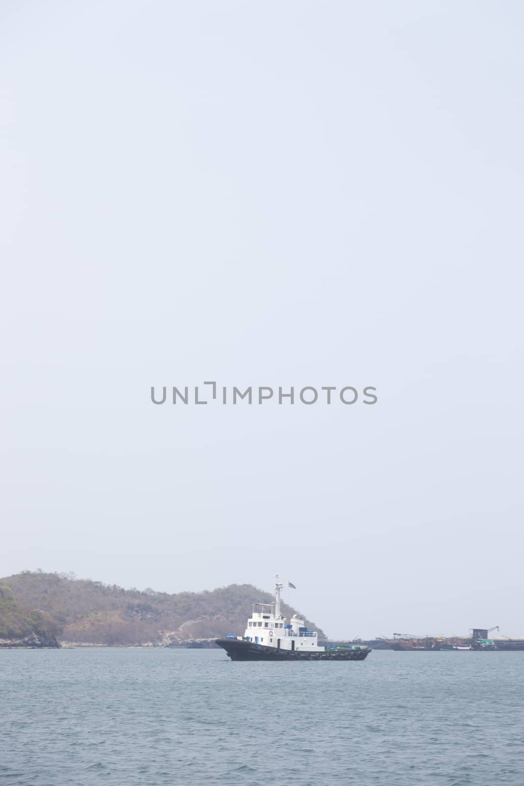 Large cargo ship Boats moored in the sea to make sense compared to the coast.