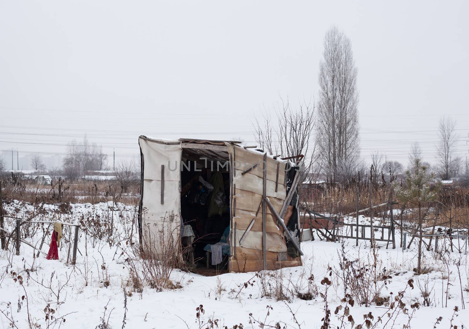 Temporary self-made shelter covered with the snow in winter.