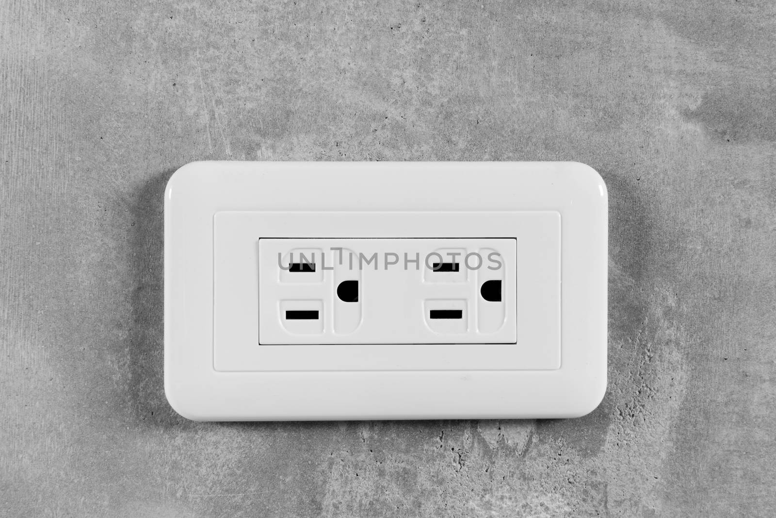 Socket, electrical outlet on gray wall. Close-up image.