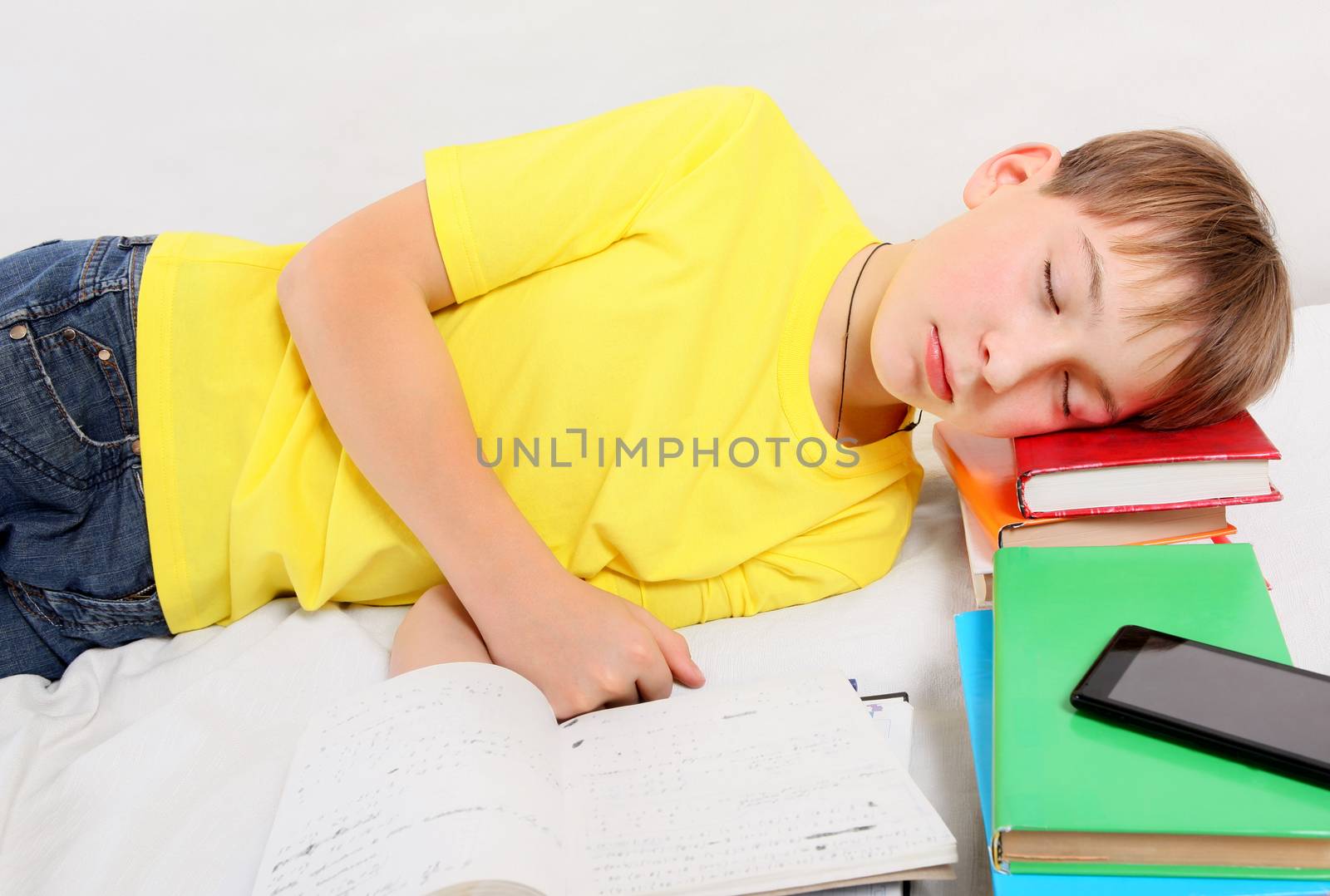 Tired Kid with the Books sleep on the Bed