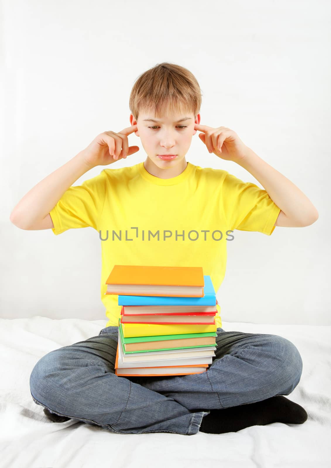 Stressed Kid with a Books cover the Ears on the Bed