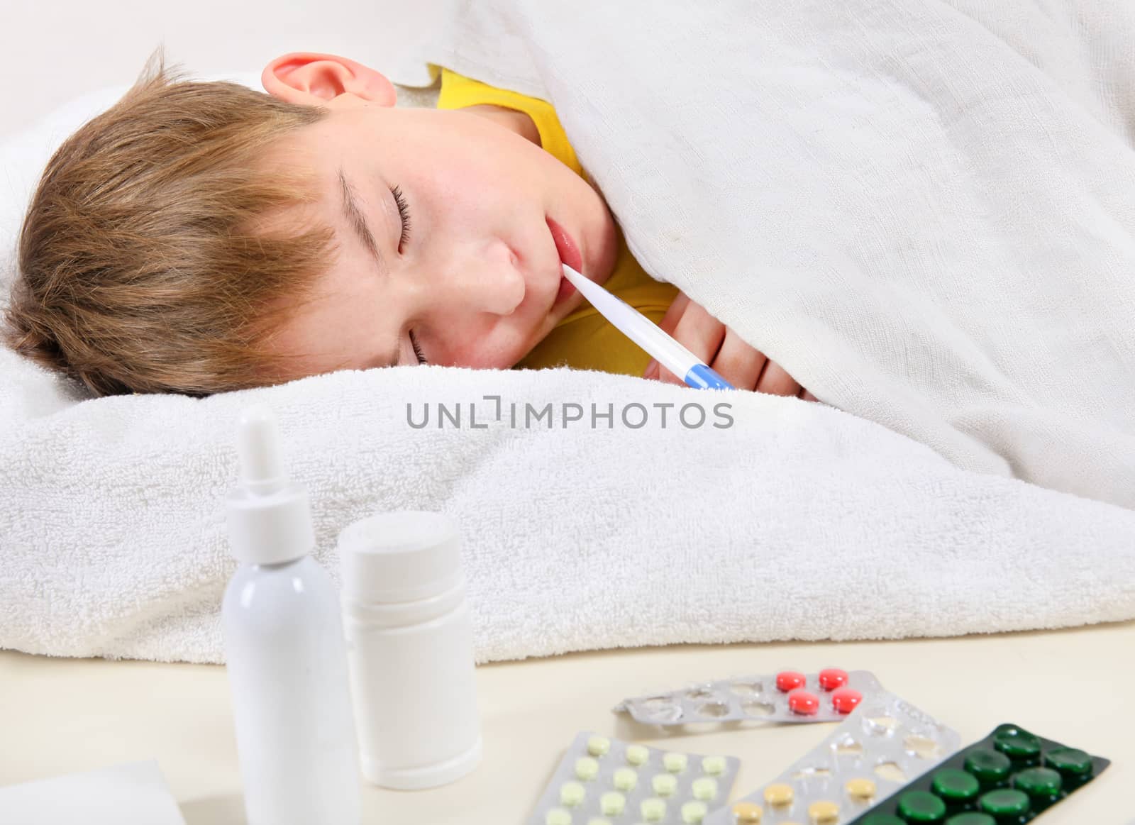 Sick Kid with Thermometer in the Bed