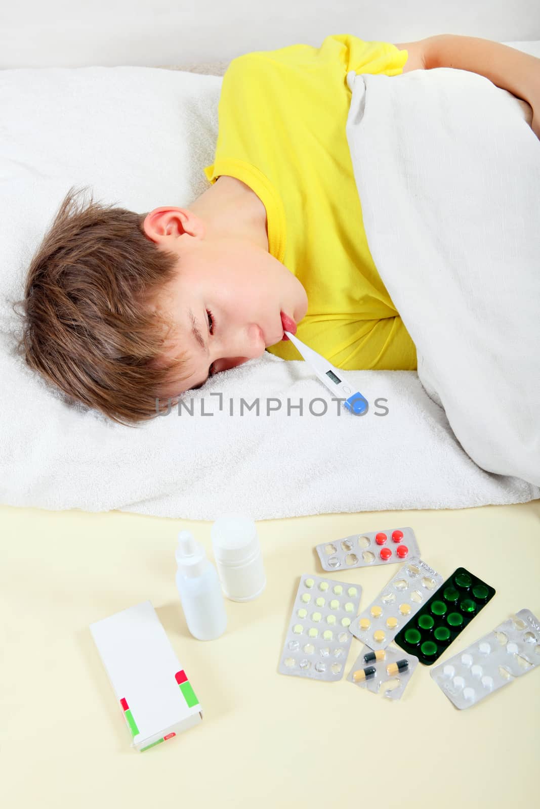 Sick Kid with Thermometer in the Bed