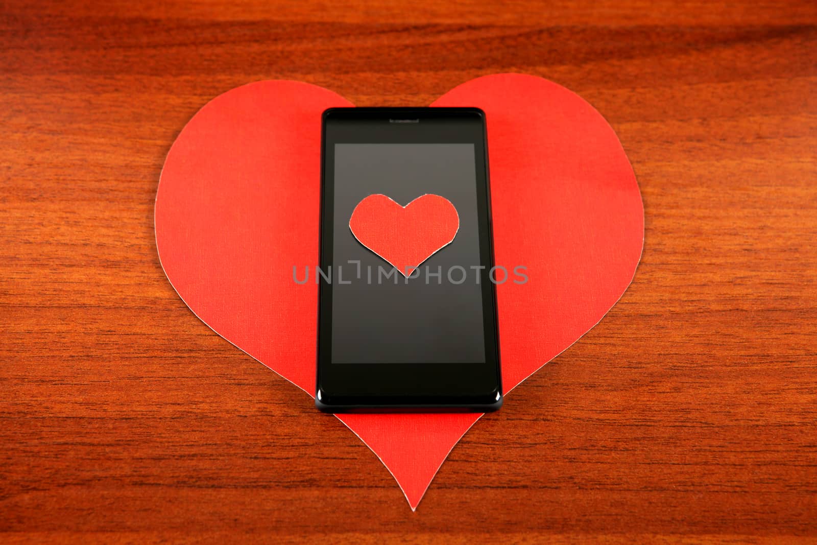 Heart Shape and Cellphone on the Wooden Background