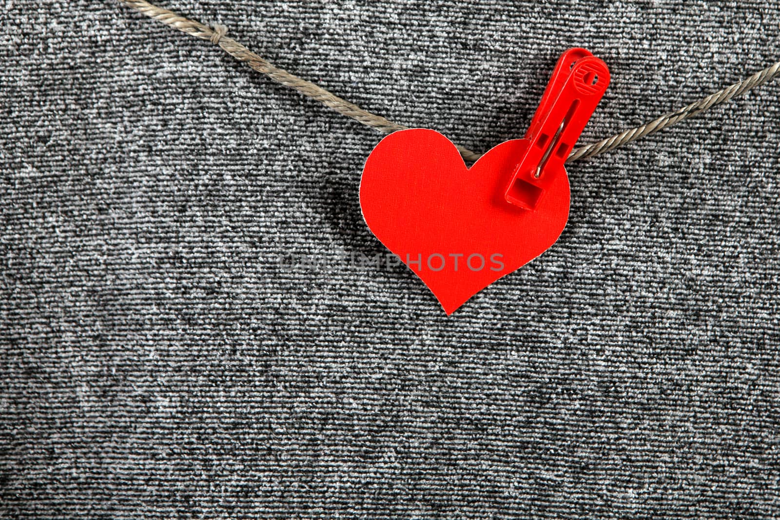 Red Heart Shape on the Rope on the Textile Background