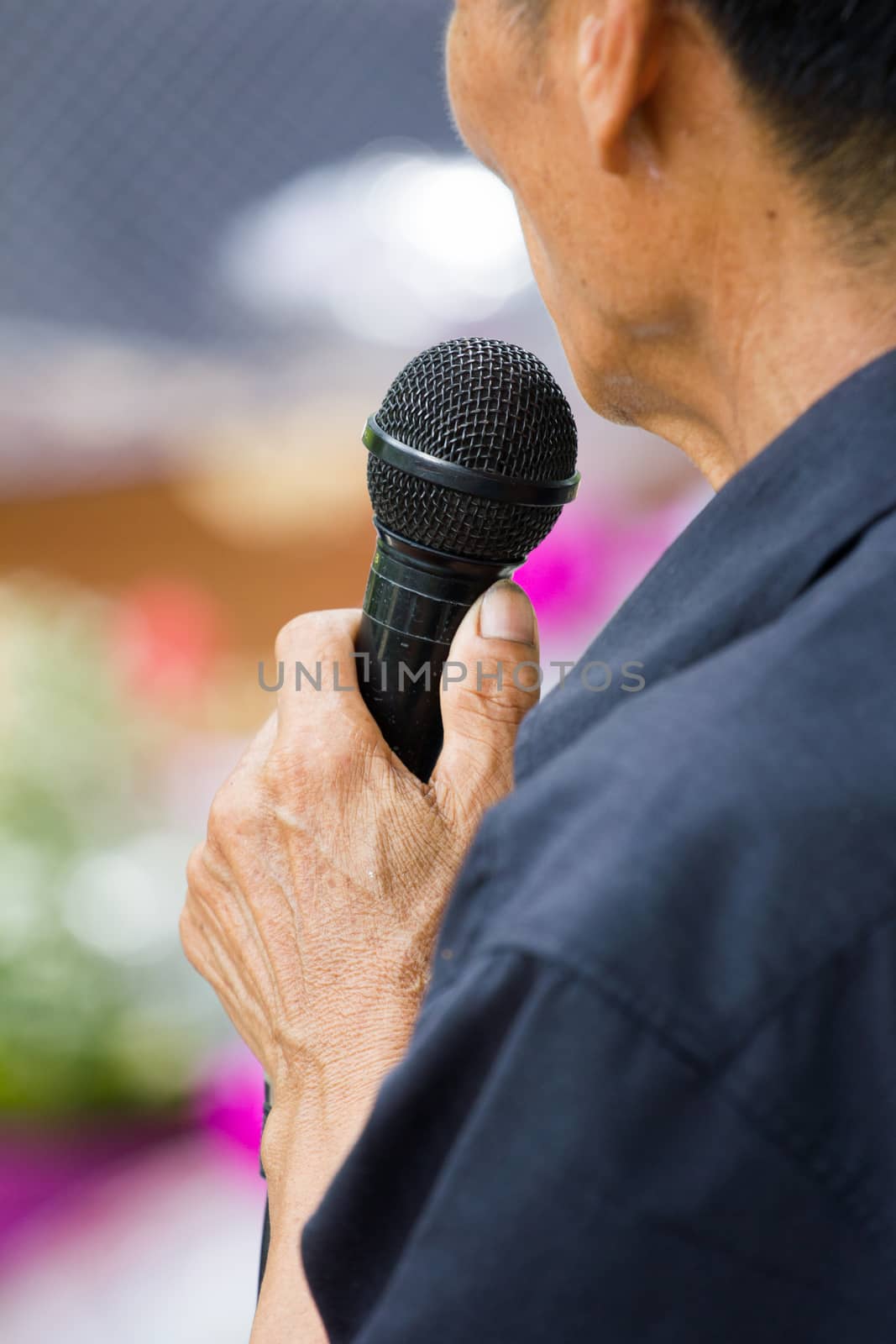 thai old man holding black microphone