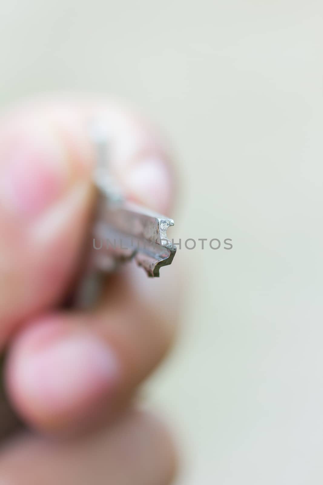 Closeup of key in hand to open. Shallow depth of field