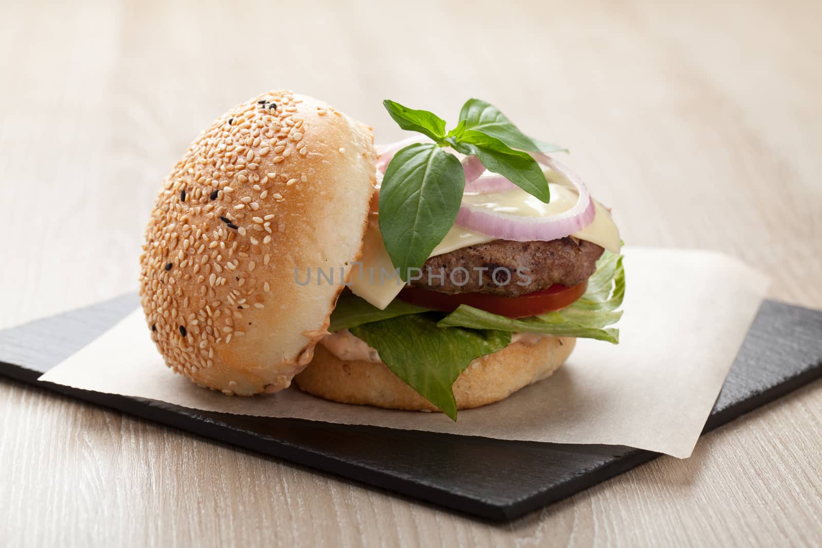 Healthy wheat sandwich burger with beef steak, cheese, tomato, lettuce, onion, basil and ketchup  served for eating