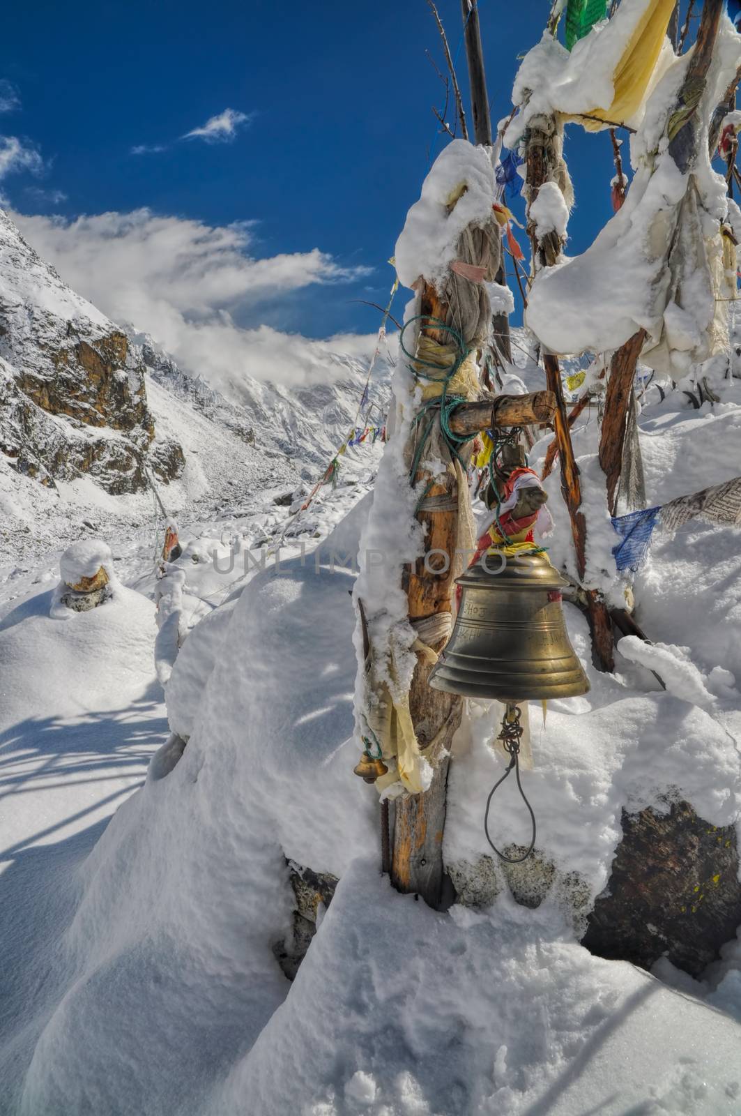 Buddhist bell and prayer flags in Himalayas near Kanchenjunga, the third tallest mountain in the world