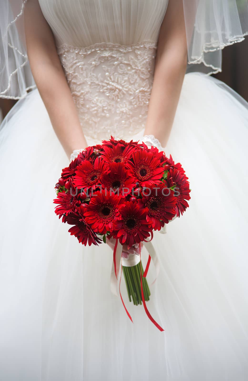 Wedding bouquet in hands of the bride. Red chrysanthemums