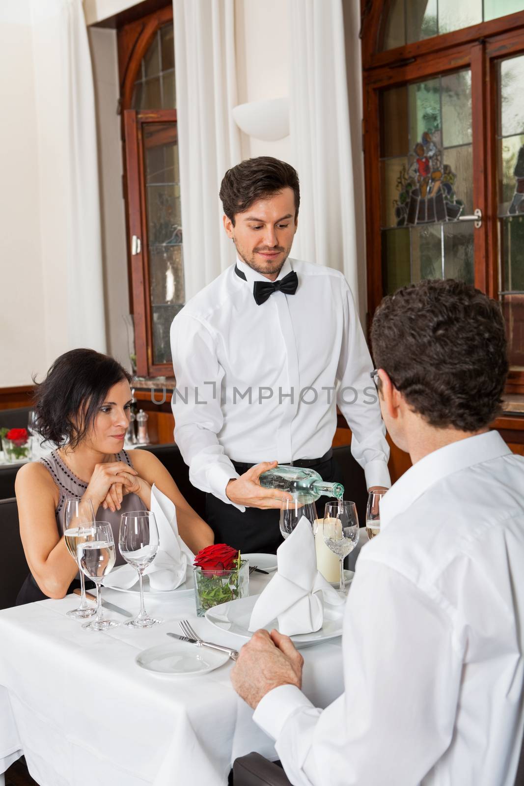 young smiling couple at the restaurant for dinner 