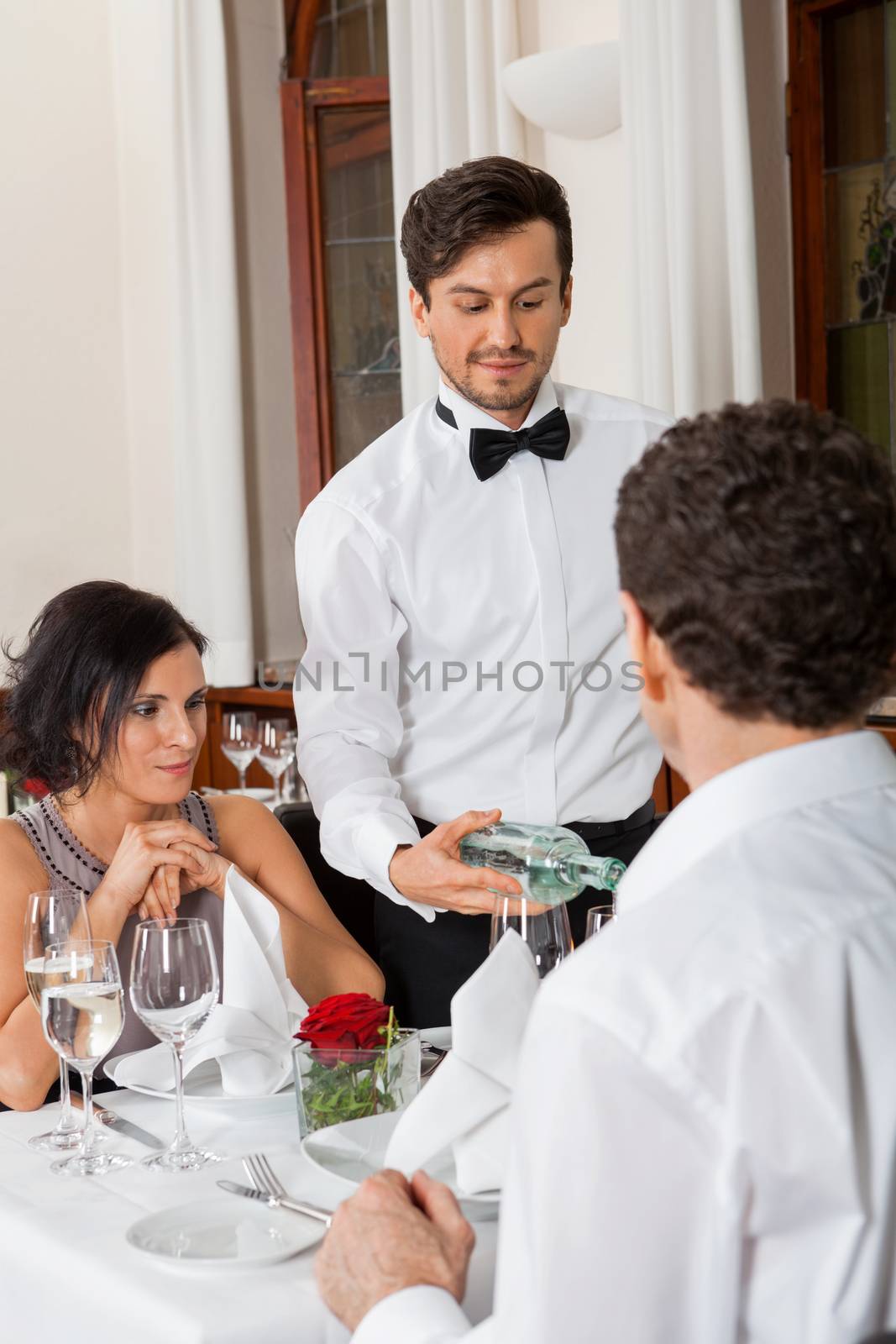 young smiling couple at the restaurant for dinner 