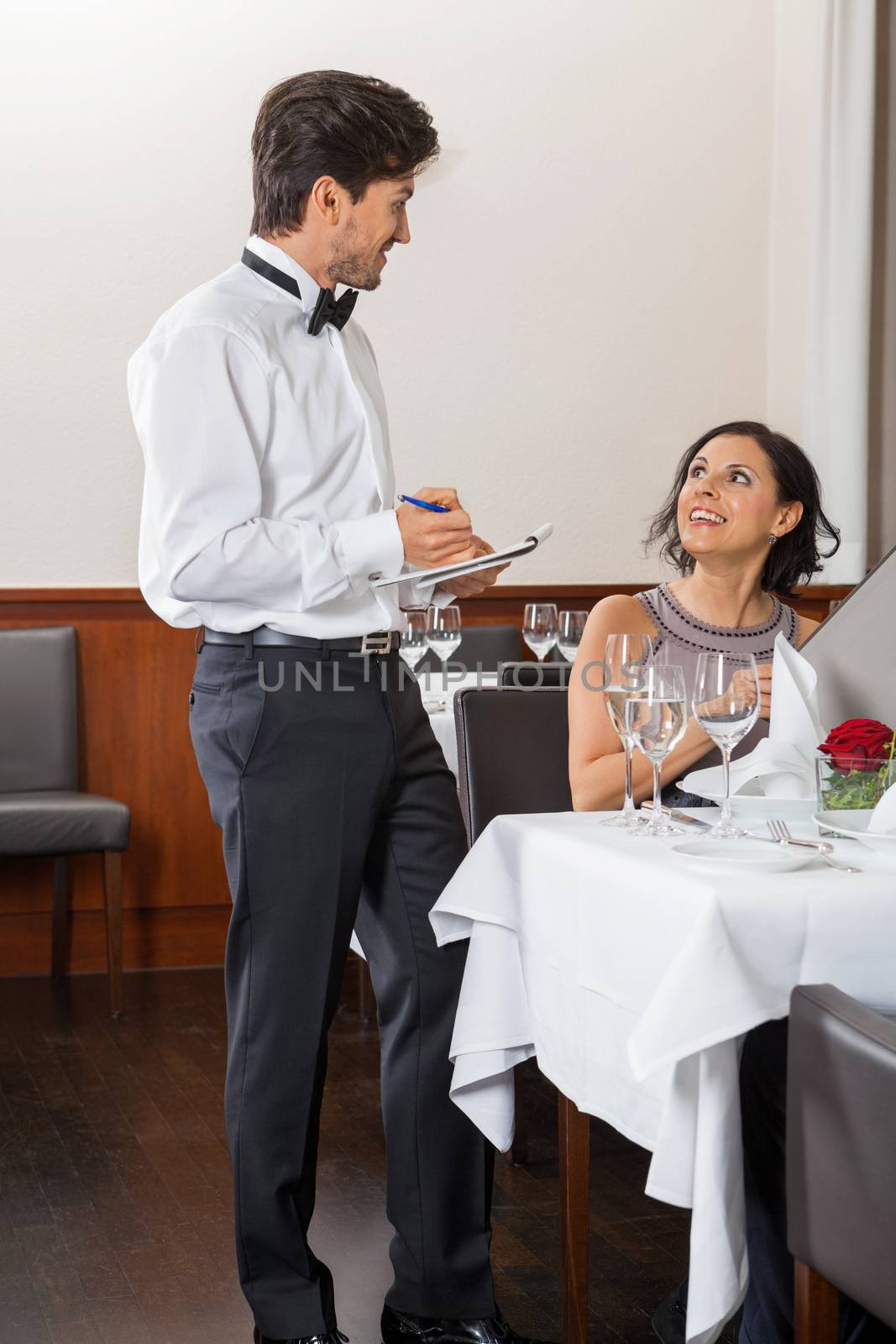 young smiling couple at the restaurant for dinner 