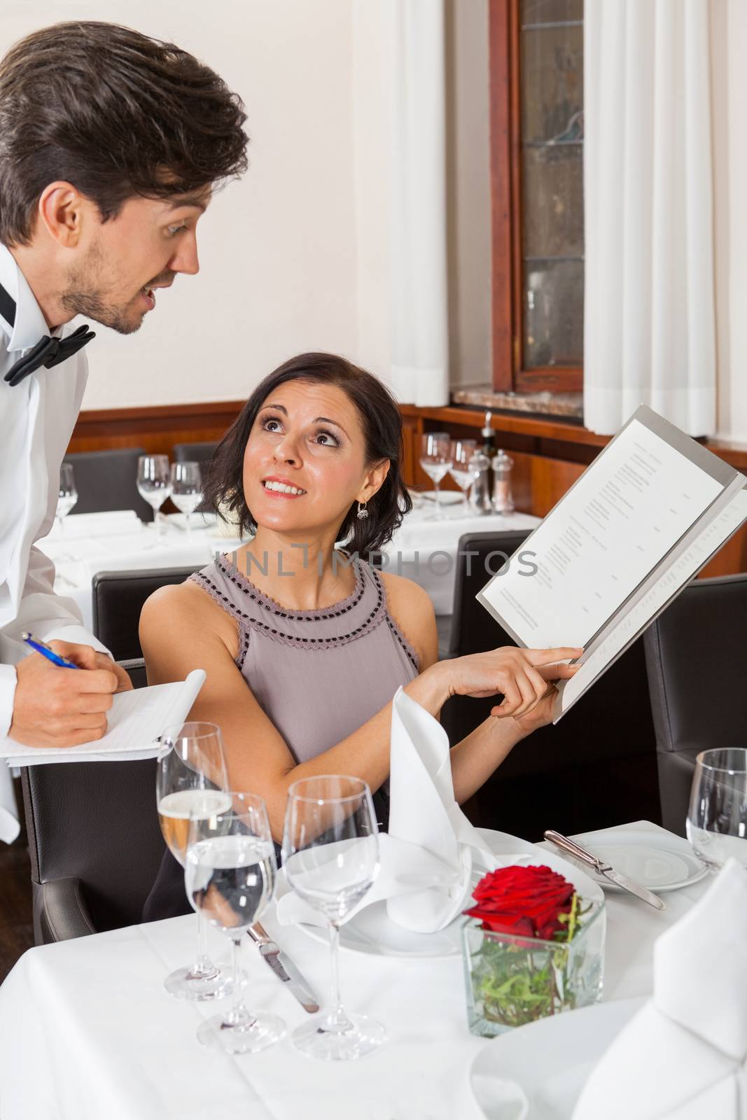 young smiling couple at the restaurant for dinner 