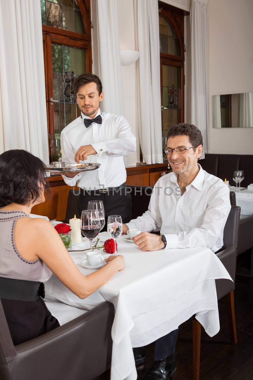 young smiling couple at the restaurant for dinner 