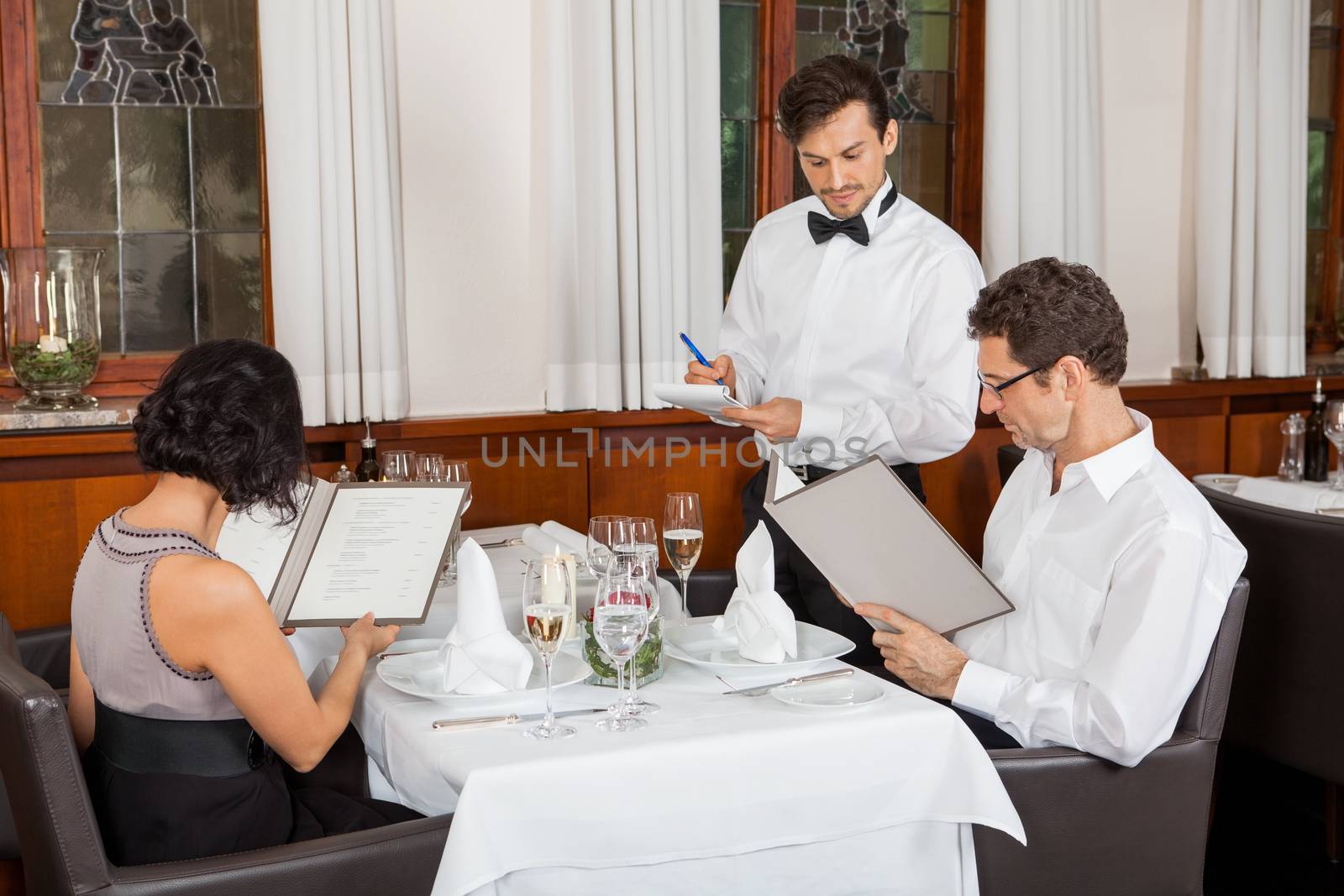 young smiling couple at the restaurant  by juniart