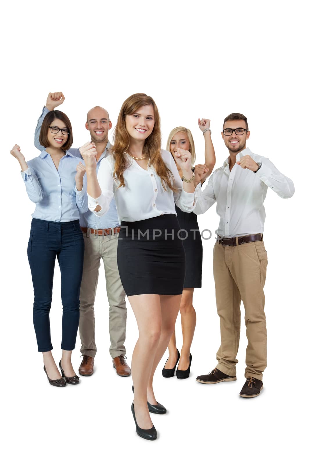 Successful business team of diverse young executives standing cheering and celebrating their success with an attractive young businesswoman or team leader in the foreground, on white