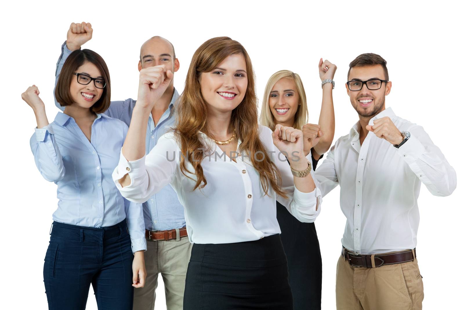 Successful business team of diverse young executives standing cheering and celebrating their success with an attractive young businesswoman or team leader in the foreground, on white