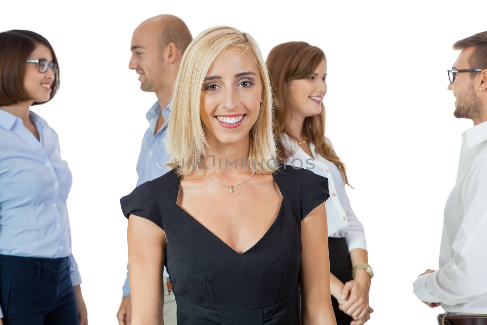 Successful business team of diverse young executives standing cheering and celebrating their success with an attractive young businesswoman or team leader in the foreground, on white