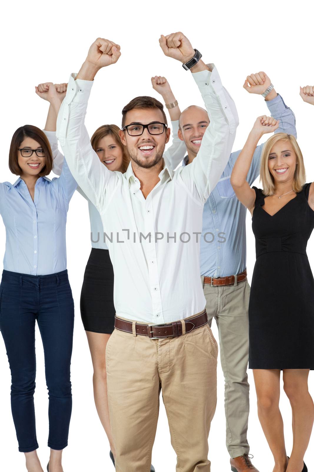 Successful business team of diverse young executives standing cheering and celebrating their success with an attractive young businesswoman or team leader in the foreground, on white