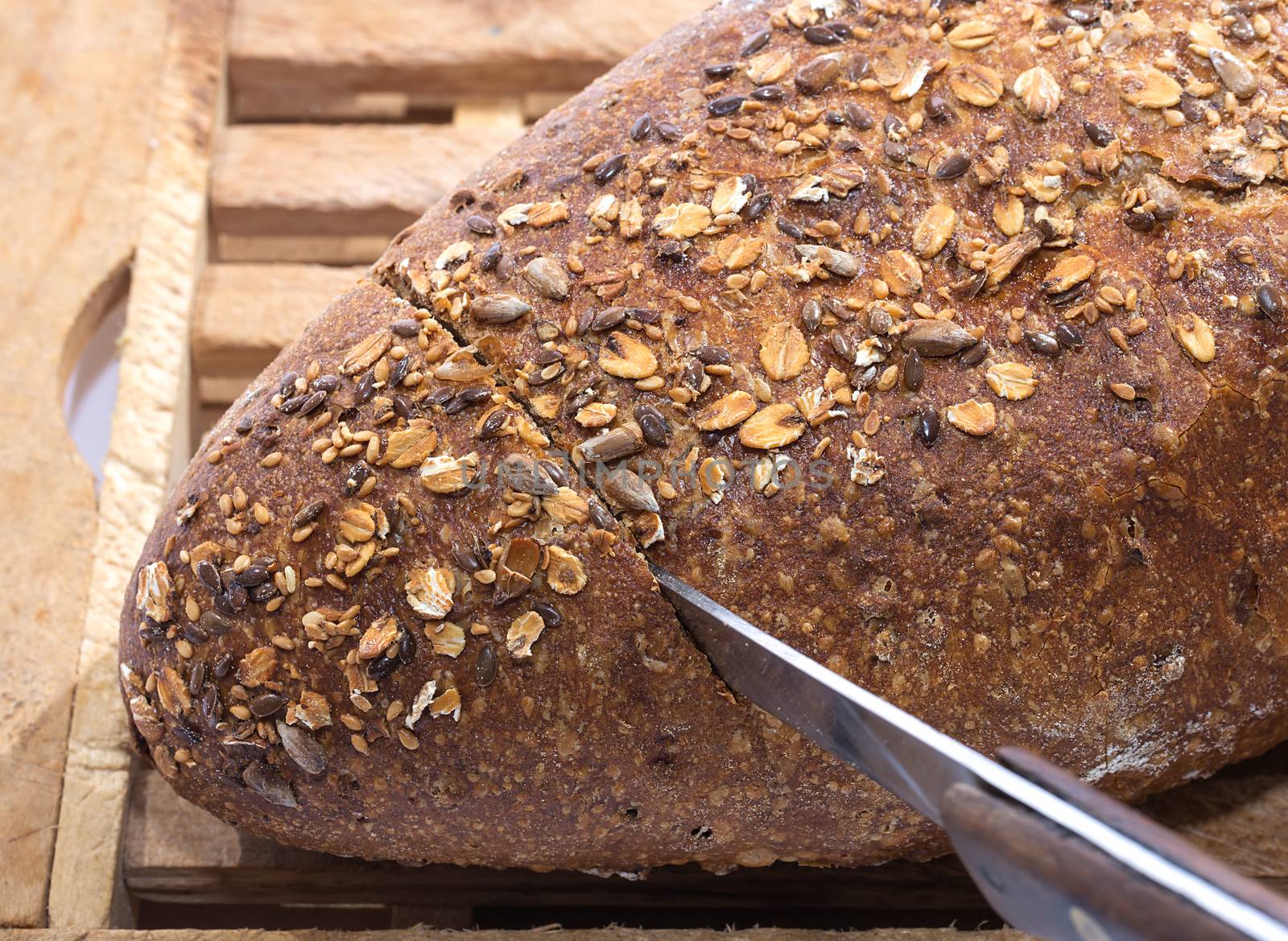 Knife Cutting Whole Grain Bread by milinz