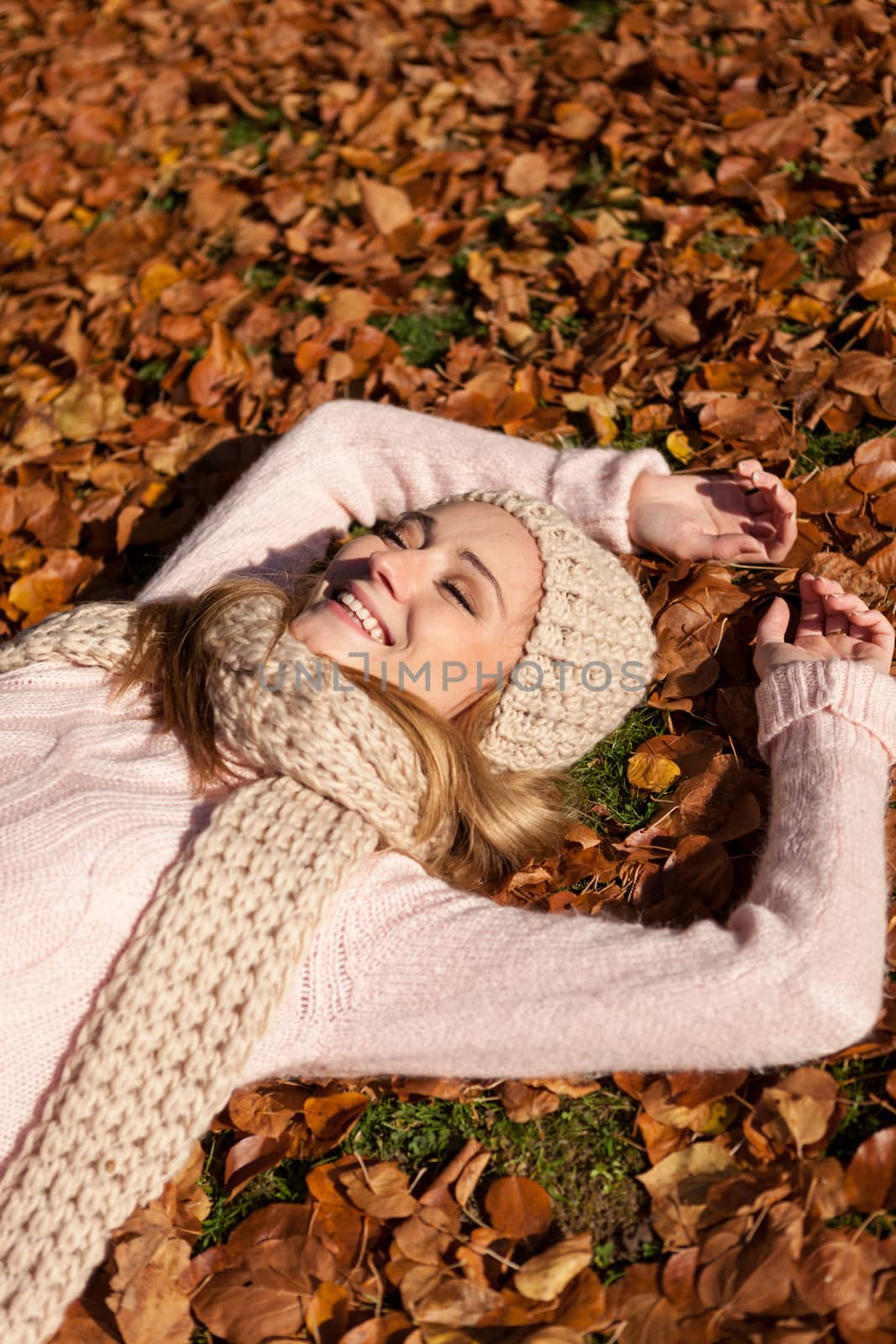 young smiling woman with hat and scarf outdoor in autumn by juniart