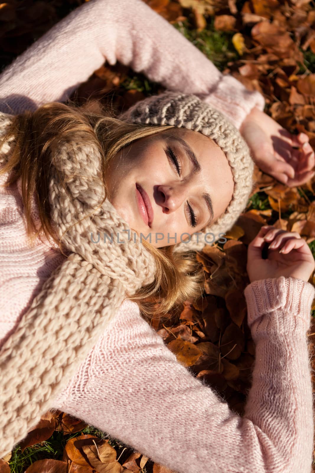 young smiling woman with hat and scarf outdoor in autumn by juniart
