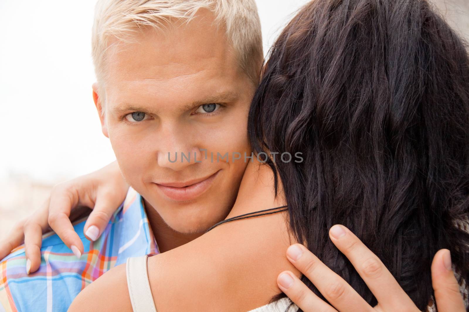 Romantic handsome man hugging his girlfriend by juniart